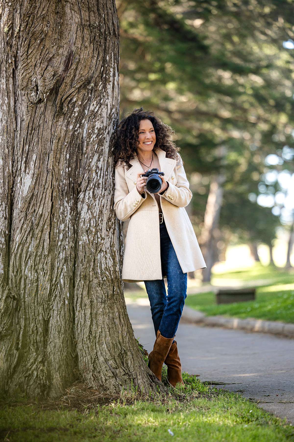 Rachel Levine San Francisco Wedding Planner and Photographer Leaning against a tree with her camera